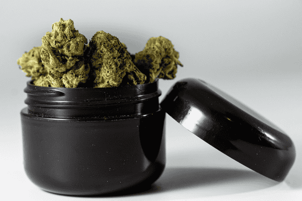curing cannabis in a black jar