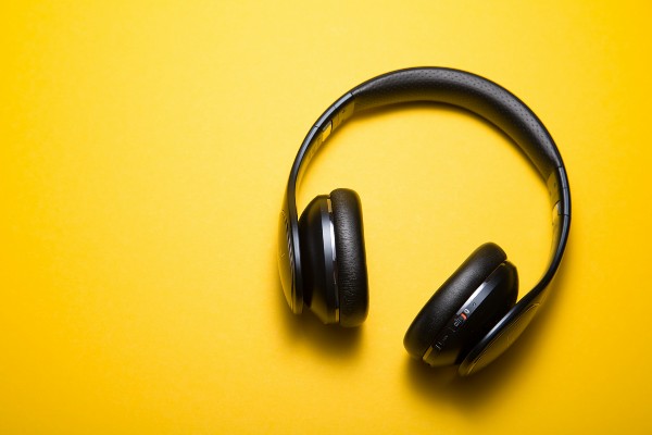 image of headphones on a music background, signaling the impact of music on cannabis plant growth